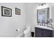 Powder room featuring a vanity with marble countertop and accent wall art at 20644 E Sunrise Ct, Queen Creek, AZ 85142