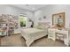Sunlit bedroom with a large window and a charming vanity desk at 20644 E Sunrise Ct, Queen Creek, AZ 85142