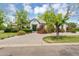 Beautiful home exterior with lush landscaping, mature trees, and a paved driveway at 20644 E Sunrise Ct, Queen Creek, AZ 85142