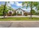 Attractive home exterior with manicured front yard, colorful flowers, and mature trees at 20644 E Sunrise Ct, Queen Creek, AZ 85142