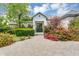 Charming home exterior with a manicured lawn, vibrant flowers, and a welcoming entrance at 20644 E Sunrise Ct, Queen Creek, AZ 85142