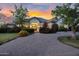 Charming single story home featuring a brick driveway, manicured landscaping and a warm, inviting entryway at 20644 E Sunrise Ct, Queen Creek, AZ 85142