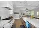 Bright kitchen featuring a professional-grade range, white cabinetry, and an open layout to adjacent living spaces at 20644 E Sunrise Ct, Queen Creek, AZ 85142