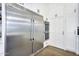 Gourmet kitchen featuring stainless steel refrigerator, double ovens, and sleek white cabinetry at 20644 E Sunrise Ct, Queen Creek, AZ 85142