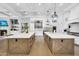 Chef's kitchen featuring dual islands, stainless appliances, custom cabinetry and an open layout for entertaining at 20644 E Sunrise Ct, Queen Creek, AZ 85142