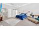 Spacious primary bedroom with a king bed, carpeting, seating area, and a barn door leading to the en suite at 20644 E Sunrise Ct, Queen Creek, AZ 85142
