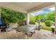 Spacious covered patio with a ping pong table overlooking the lush green backyard at 20644 E Sunrise Ct, Queen Creek, AZ 85142