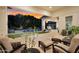 Stylish covered patio with plush seating and a view of the backyard pool at sunset at 20644 E Sunrise Ct, Queen Creek, AZ 85142