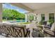 Serene covered patio overlooking a sparkling pool and manicured backyard, perfect for relaxation at 20644 E Sunrise Ct, Queen Creek, AZ 85142