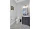 Charming powder room with a marble vanity top and grey hexagonal tile flooring at 20644 E Sunrise Ct, Queen Creek, AZ 85142