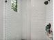 Modern shower featuring white subway tile, a rain shower head, and window at 20644 E Sunrise Ct, Queen Creek, AZ 85142