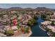 A waterfront property showcasing meticulous landscaping and serene lakeside living near surrounding mountains at 20986 N 66Th Ln, Glendale, AZ 85308