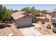 A well-kept home with a desert landscape, a two-car garage, and a tiled roof in a quiet neighborhood at 20986 N 66Th Ln, Glendale, AZ 85308