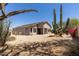 Rear view of house featuring desert landscaping, a covered patio, offering a blend of indoor-outdoor living at 20986 N 66Th Ln, Glendale, AZ 85308