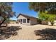 Spacious backyard featuring desert landscaping, a covered patio, perfect for relaxation and low-maintenance living at 20986 N 66Th Ln, Glendale, AZ 85308