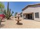 Expansive backyard featuring desert landscaping, a charming fountain, and covered patio, perfect for outdoor enjoyment at 20986 N 66Th Ln, Glendale, AZ 85308