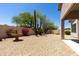 Desert-landscaped backyard featuring a fountain, native plants, and ample space for outdoor activities at 20986 N 66Th Ln, Glendale, AZ 85308