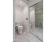 Modern bathroom featuring tiled floors, toilet, and glass-enclosed shower at 20986 N 66Th Ln, Glendale, AZ 85308