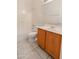 Bright bathroom featuring a vanity with wood cabinets, a large mirror, and a shower-tub combination at 20986 N 66Th Ln, Glendale, AZ 85308