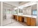 Spacious bathroom with dual vanities, tile floors, and a large mirror at 20986 N 66Th Ln, Glendale, AZ 85308