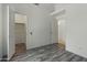 Bedroom with laminate wood floors, closet and en-suite at 20986 N 66Th Ln, Glendale, AZ 85308