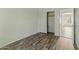 Bedroom with hardwood floors, closet, and view into hallway at 20986 N 66Th Ln, Glendale, AZ 85308