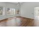 Bright bedroom with hardwood floors, three windows, and a ceiling fan at 20986 N 66Th Ln, Glendale, AZ 85308