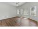 Bright bedroom featuring hardwood floors, white walls, and large windows at 20986 N 66Th Ln, Glendale, AZ 85308