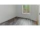 Empty bedroom with laminate wood floors and a bright window at 20986 N 66Th Ln, Glendale, AZ 85308