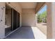 Relaxing covered patio with a sliding glass door, providing seamless indoor-outdoor living, and a gravel yard at 20986 N 66Th Ln, Glendale, AZ 85308