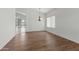 Bright, empty dining room with chandelier and wood-look floors offers space for entertaining at 20986 N 66Th Ln, Glendale, AZ 85308