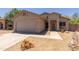 Charming single-story home featuring a stucco facade, desert landscaping, and attached two-car garage at 20986 N 66Th Ln, Glendale, AZ 85308