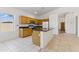 Kitchen with island, tile floors, oak cabinets, and granite counters has a great layout at 20986 N 66Th Ln, Glendale, AZ 85308