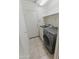 Efficient laundry room featuring modern washer and dryer units, shelving, and direct access to the outside at 20986 N 66Th Ln, Glendale, AZ 85308