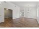 Inviting living area with wood floors, neutral paint, and classic chandelier. The space is open and bright at 20986 N 66Th Ln, Glendale, AZ 85308