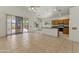 Open-concept living room with tiled floors and kitchen access creates a great gathering space at 20986 N 66Th Ln, Glendale, AZ 85308
