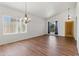 Bright living room with hardwood floors, vaulted ceiling, and natural light from large windows at 20986 N 66Th Ln, Glendale, AZ 85308