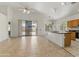Tile-floored living room offers an open floor plan, leading to the kitchen and outdoor patio at 20986 N 66Th Ln, Glendale, AZ 85308