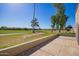 Relaxing back patio overlooking the golf course, mature trees, and lush green landscaping at 2211 N Recker Rd, Mesa, AZ 85215