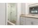 Bathroom with glass enclosed shower, vanity with drawers and cabinets, and neutral color palette at 2211 N Recker Rd, Mesa, AZ 85215