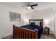Cozy bedroom featuring wood furniture, ceiling fan, and window providing natural light at 2211 N Recker Rd, Mesa, AZ 85215