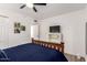 Comfortable bedroom with blue bedding, ceiling fan, and view to ensuite bathroom at 2211 N Recker Rd, Mesa, AZ 85215