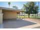 The carport offers covered parking next to lush greenery and mature trees at 2211 N Recker Rd, Mesa, AZ 85215
