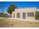 Attractive home with stucco, a decorative archway, desert landscaping and plenty of sunlight at 2211 N Recker Rd, Mesa, AZ 85215