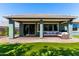 Spacious covered patio with comfortable seating overlooks a well-maintained lawn at 23179 S 225Th Pl, Queen Creek, AZ 85142