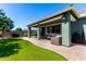Outdoor living space with a covered patio, barbecue grill, and a manicured lawn at 23179 S 225Th Pl, Queen Creek, AZ 85142