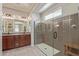 Bright bathroom featuring a double vanity, large mirror, and luxurious glass-enclosed shower with a built-in bench at 23179 S 225Th Pl, Queen Creek, AZ 85142