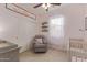 Cozy Bedroom with a crib, chair, neutral carpet, and white door at 23179 S 225Th Pl, Queen Creek, AZ 85142