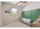 Inviting room with gray couch, green paneling, and a window at 23179 S 225Th Pl, Queen Creek, AZ 85142