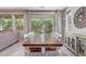 Bright dining room with large windows offering a serene view of the outdoor greenery at 23179 S 225Th Pl, Queen Creek, AZ 85142